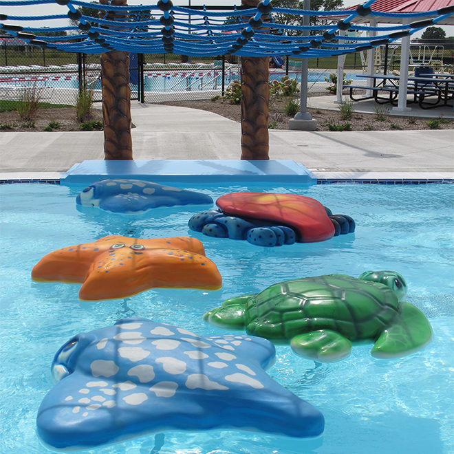 water walk at a swimming pool, floatable steps in the shapes of large marine life. star fish, turtle, crab, sting ray